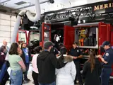 Firefighters talking to a group of people at the Fire Station